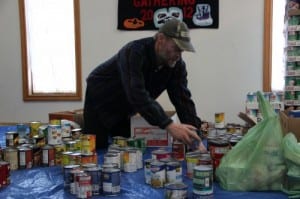 A volunteer sorts food at the Salvation Army. (KCAW photo/Emily Forman)