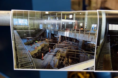  Before and after photos lined the railing. Here is the powerhouse before generation equipment was installed. (Emily Kwong/KCAW photo).