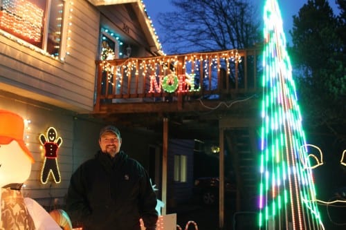 Mike Romine stands in front of his home on Wachusetts Street. He even provided a low-power FM signal so viewers could listen to holiday music in their vehicles. (KCAW photo/Brielle Schaeffer)