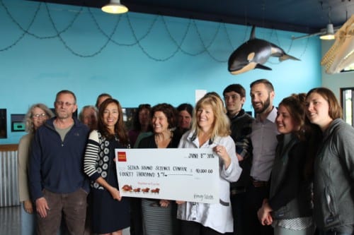 Sitka Sound Science Center staff accept a check from Judith Cr