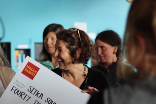 Lisa Busch, executive director of the Sitka Sound Science Center, smiles as she accepts a check for $40,000 from Wells Fargo. The money will be used to design a seawater heat pump for the center. 