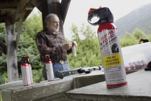 Former Alaska Department of Fish and Game biologist John Hechtel examines a can of inert bear spray during a training session focusing on bear deterrents in Wrangell, Alaska. The session was part of the fifth annual Wrangell Bearfest celebration in 2014. (Flickr photo/James Brooks)