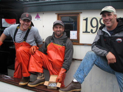 Crew aboard the F/V Sequoia show off their Xtratufs. Production of the popular boot is moving overseas. (KCAW photo by Ed Ronco)