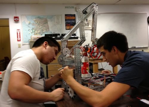 Mt. Edgecumbe students Gusty Akelkok (l) and Nick Bouker (r) prep their robot for the state meet. (MEHS photo/Mark Nance)