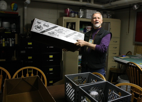 Charlie Bean uses fish boxes to pack up his workspace at the Bill Brady Healing Center. He jokes that people in other states probably don't use fish boxes like this. (KCAW photo by Ed Ronco)