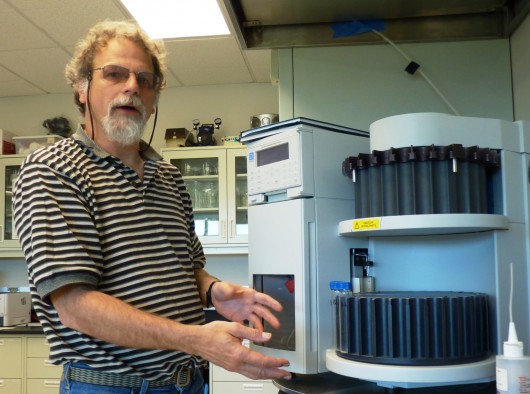 Ron Heintz discusses the gulf groundfish project while checking equipment in one of NOAA's Juneau labs. Photo by Ed Schoenfeld, CoastAlaska News.