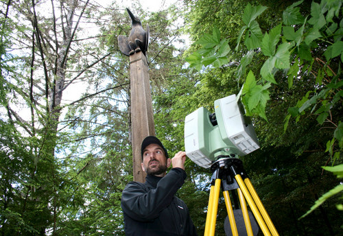 National Parks Service architect Jeremy Mauro operates a machine to digitally scan totem poles in Sitka's National Historical Park. 