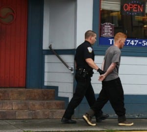 Tyler Westlund, 22, is taken into custody by Sitka police. Westlund is accused of running from the Pioneer Bar with a gun that had just been fired inside the bathroom. He's charged with tampering with physical evidence.