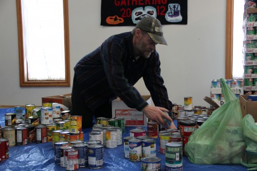 A Salvation Army Volunteer sorts Thanksgiving canned goods.(photo by KCAW's Emily Forman)