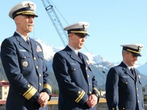From right to left: Coast Guard District 17 commander Rear Admiral Thomas Ostebo; Maple executive officer Lt. Raymond Reichl; and Lt. Commander Michael Newell bowed their heads during the chaplain's invocation during the Assumption-of-Command ceremony. (KCAW photo/Rachel Waldholz)