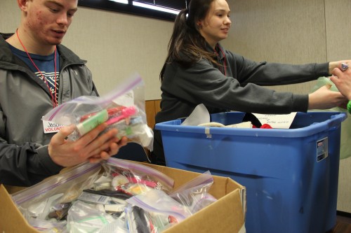 Mt. Edgecumbe High School seniors hand out socks and toiletries at Project Homeless Connect.