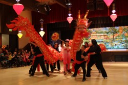 The Mayo family performs a traditional dragon dance for Chinese New Year. (KCAW photo/Emily Forman)