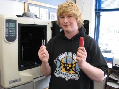 Sitka High senior Thor Becker with the product (l.) and the  prototype bit  made in this 3D printer. (KCAW photo/Robert Woolsey)