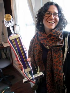 Forman hefts the triathlon trophy she delivered -- as promised -- for the station. (KCAW photo/Robert Woolsey)
