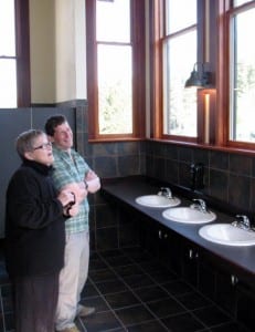 Carol Odess and Roger Schmitd take in the jaw-dropping view from the new women's restroom in Allen Hall. (KCAW photo/Robert Woolsey)