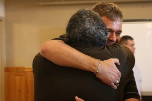 Lt. Lance Leone, right, hugs Darryl Penn, a La Push resident who helped rescue him from a helicopter crash. Leone visited La Push at the fourth anniversary of the July 7, 2010 crash. (Photo: Ed Ronco/KPLU)