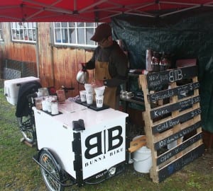 Chris Bryner brews direct-trade coffee at his new coffee cart in Sitka. (KCAW/photo by Greta Mart)