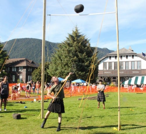 Alan Maloney competes in the sheaf toss at Sitka Seafood Festival's 2014 Highland Games, sending his bale over the 15 foot bar. (KCAW  photo/Rachel Waldholz)