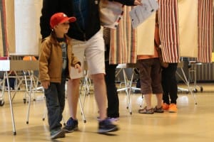 Matthew Lowe brought his son, Roland, to the polls on primary day. (KCAW photo/Rachel Waldholz)