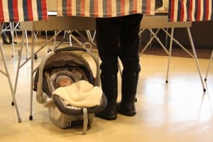 Maggie Gallin brought her son, Theo, to the polls on Tuesday, to vote in Alaska's primary election (KCAW photo/Rachel Waldholz)