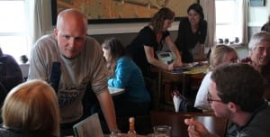 State Representative Jonathan Kreiss-Tomkins speaks with voters at Sitka's Larkspur Cafe. (KCAW photo/Rachel Waldholz)