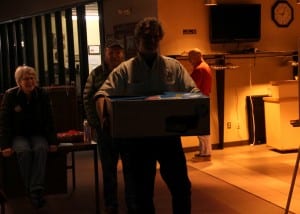 Mayor Mim McConnell looks on as ballots from Sitka's Municipal Election are carried in to the city clerk. She learned she had been reelected minutes later. (KCAW photo/Rachel Waldholz)