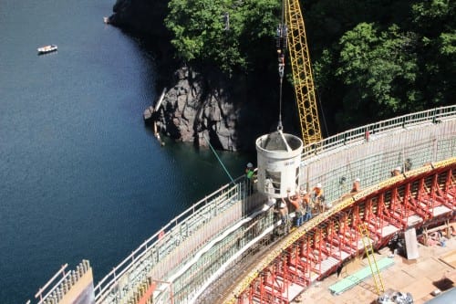 Workers pouring cement at the Blue Lake dam in June, 2014 (KCAW photo/Rachel Waldholz)