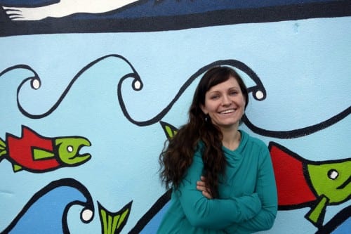 "My favorite part is when I get to put red on something, on a blank wall," said Cara Jane Murray, a local artist who painted the mural over the winter break. (Emily Kwong/KCAW photo)
