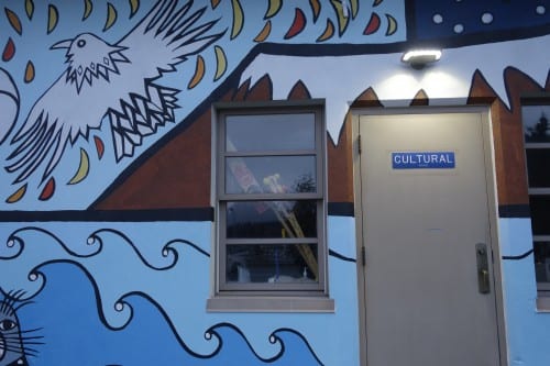 The mural was painted on the front of the Cultural Building, where a variety of after-school programs are taught. Pictured here are a raven and a moose, to represent Interior Alaska. (Emily Kwong/KCAW photo)