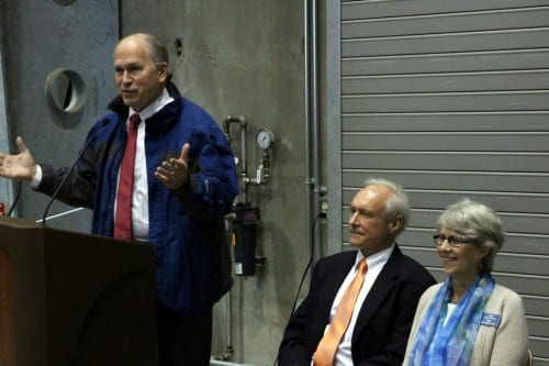 Governor Bill Walker addressed the crowd at the Blue Lake dam dedication ceremony. Seated next to him are City Administrator Mark Gorman and Mayor Mim McConnell. (Emily Kwong/KCAW)