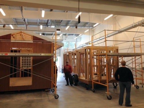 Sitka's wood shop/construction teacher Mike Vieira says the first thing he noticed when he brought his classes indoors was "increased productivity." Three buildings are in progress in the CTE, including a Tiny Home, at right. (KCAW photo/Robert Woolsey)