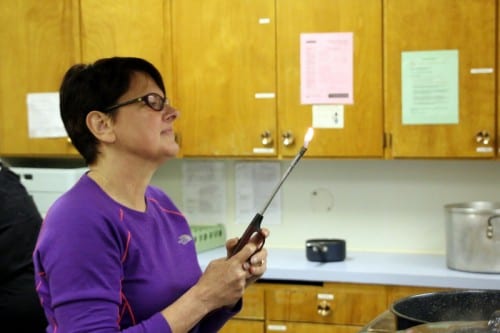 Sitka residents learn how to pickle and ferment fruits and vegetables at Sitka Kitch in mid-July. Pictured above, instructor Sarah Lewis of UAF's Cooperative Extension. KCAW photo/Vanessa Walker.