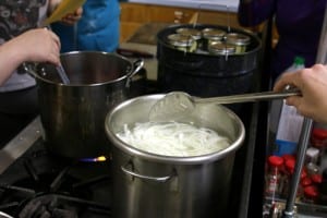 Sitka residents learn how to pickle and ferment fruits and vegetables at Sitka Kitch in mid-July. Pictured above, instructor Sarah Lewis of UAF's Cooperative Extension. KCAW photo/Vanessa Walker.