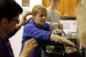 Sitka residents learn how to pickle and ferment fruits and vegetables at Sitka Kitch in mid-July. Pictured above, instructor Sarah Lewis of UAF's Cooperative Extension. KCAW photo/Vanessa Walker.