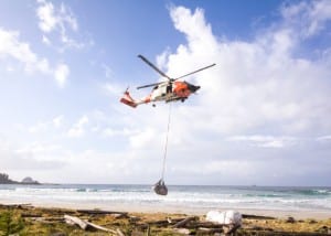A Coast Guard helicopter lifts one of several bags of marine debris collected in 2014 on Biorka Island, near Sitka. (Photo courtesy Sitka Sound Science Center)