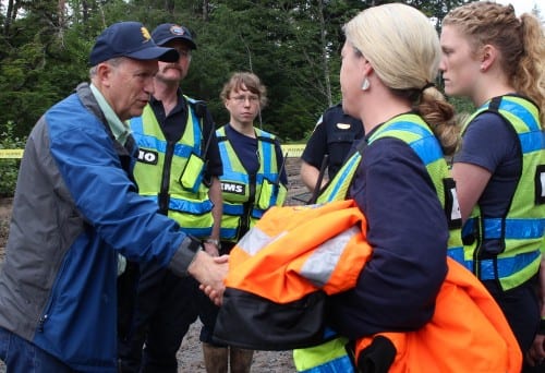 Alaska Gov. Bill Walker greets Kim Nekeferoff and other Sitka Fire Department personnel Tuesday morning. The Red Cross is helping organize meals for over 150 relief workers involved in the recovery. (KCAW photo, Rachel Waldholz)