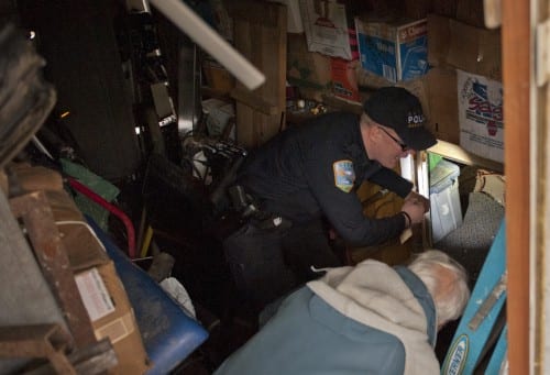 Sitka police lieutenant Lance Ewers and landlord Marcel Prato examine a tunnel system that Jeremy Beebe had excavated under his home in the Vitskari Trailer Court. (Daily Sitka Sentinel photo/James Poulson)