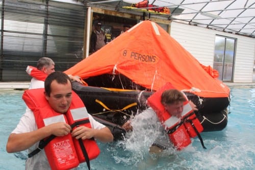Army Corps of Engineers staff conduct a life raft drill in Norfolk, VA. The "out-of-water survival craft" carried by small commercial vessels don't have to be this sophisticated, but they will be costly. (Flickr photo/Army Corps of Engineers)