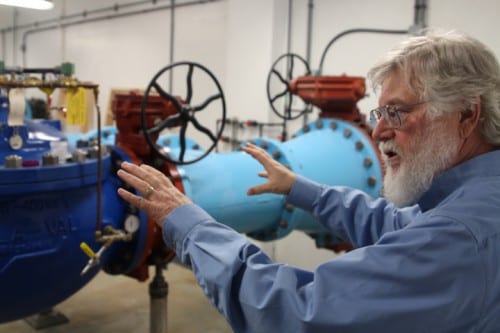 Project engineer Stephen Weatherman explains how all of Sitka's water is run through the 24-inch pipes in the plant. ( KCAW photo/Robert Woolsey)
