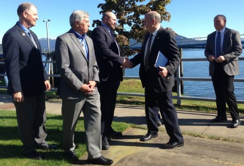 Gov. Bill Walker shakes hands with Southeast Conference President Gary White on Thursday at the Auke Bay Ferry terminal after signing an agreement to consider changes to Marine highway management. Transportation Commissioner Marc Luiken, left, Lt. Gov. Byron Mallott, second from left, and ferry Capt. Mike Neussl, right, look on. (Photo by Ed Schoenfeld/CoastAlaska News)