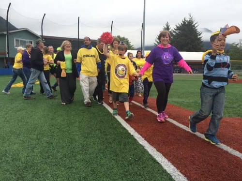Carrie Spackman leads a group of cancer survivors and their caregivers around the bases at last weekend's Relay For Life event (Photo KCAW/Katherine Rose). 