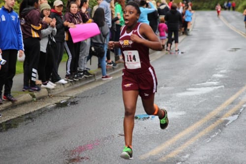 A Mt. Edgecumbe runner celebrates near the finish line.  (KCAW Photo/Emily Russell).