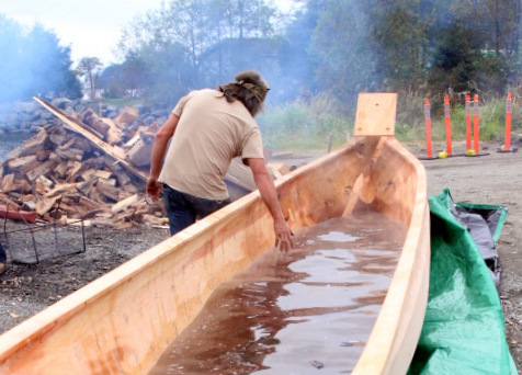 Tommy Joseph feels the warm water after the batch of lava rocks are taken out. (KCAW Photo/Emily Russell)