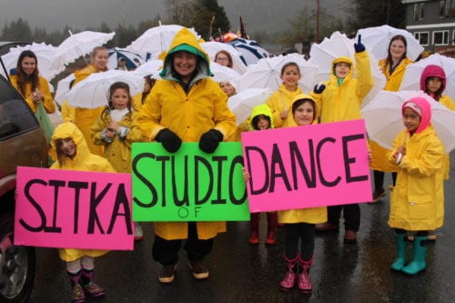 The Sitka Studio of Dance staying dry in the 2016 Alaska Day parade. (KCAW Photo/Emily Russell)