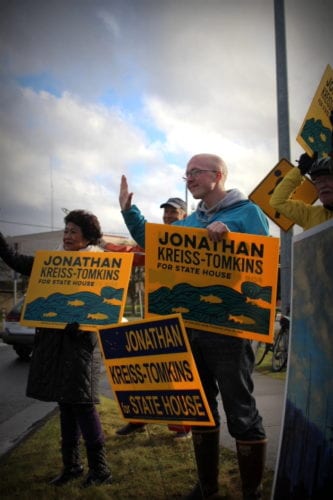 Incumbent Jonathan Kreiss-Tomkins waves to drivers in downtown Sitka. (Emily Russell/KCAW Photo)