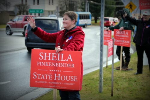 Sheila Finkenbinder spent her lunch hour waving to voters at the Lake Street roundabout. (Emily Russell/KCAW Photo)