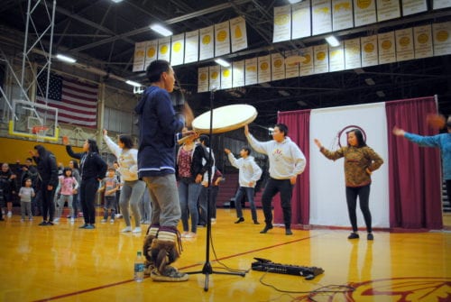 Mt. Edgecumbe students dance as Byron Nicholai sings and drums. (Emily Russell/KCAW)