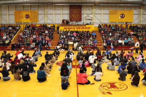 Students dance alongside Dancers by the Sea, a group from Port Lions, in celebration of Founders Week. (Emily Russell/KCAW)