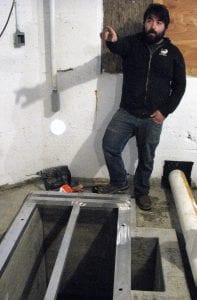 Blake Conaway, hatchery maintenance manager, explains plans for a recirculation system in the egg room. (Ed Schoenfeld/CoastAlaska News)