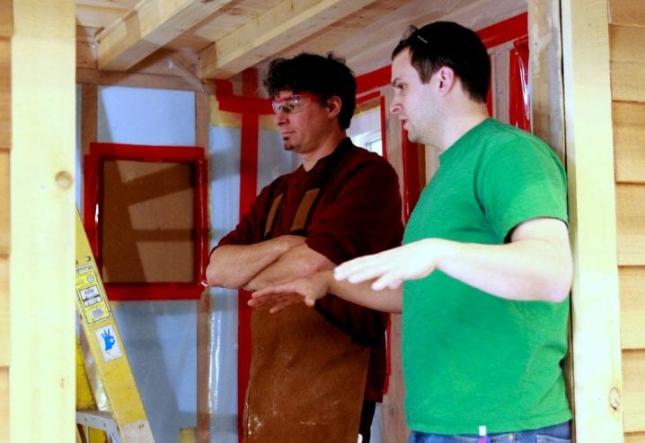 Sitka Conservation Society director Andrew Thoms (l.) is hands-on this project. He'd like to find a buyer for the tiny home, and to nudge Sitka toward allowing tiny homes in residential zones. (KCAW photo/Robert Woolsey)